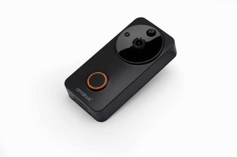 A black Amalock DB101 wireless video doorbell branded with the Amalock logo with a camera and an orange LED light ring on the front on a white background