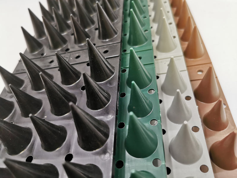 Close up of DefendaStrip 'Flex' anti-climb spike strips in black, green, grey and brown colours