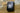 Image of a Squire Keykeep™1 black die-cast alloy steel heavy-duty and high security 4 wheel recodable combination lock outdoor key safe fixed on a brick wall.